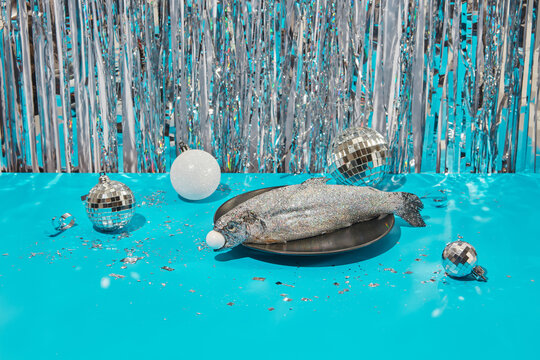 Fish decorated with glitter served on festive table