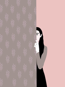 Woman hiding behind a wall