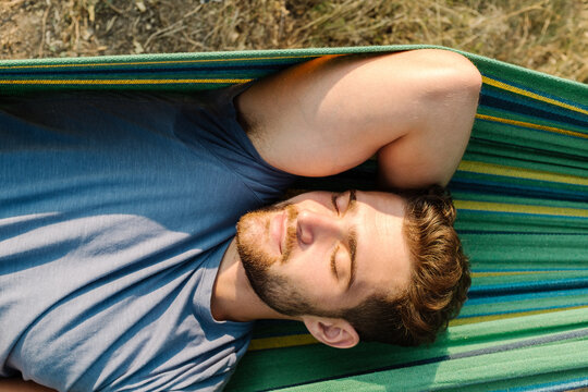Man Sleeping In A Hammock