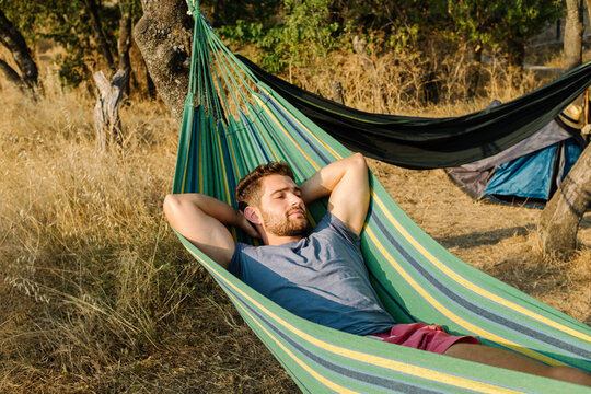 Man Sleeping In A Hammock