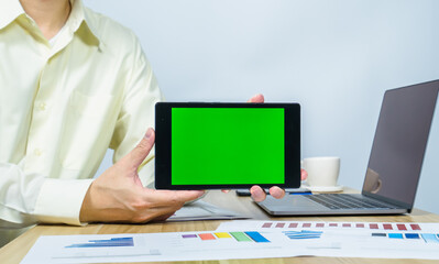 man show green screen on tablet for making meeting presentation