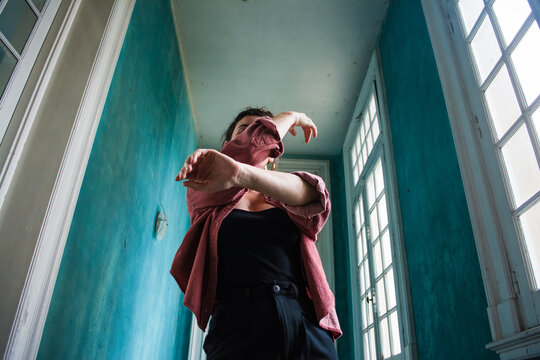 Woman hiding her face while dancing