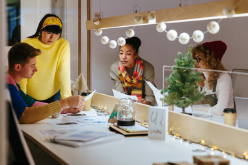 Multiracial coworkers doing paperwork together