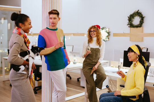 Diverse coworkers chatting in Christmas evening
