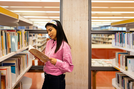 Young woman  browsing book at bookstore