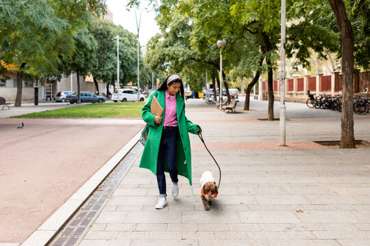 Asian woman taking a walk with her doggy