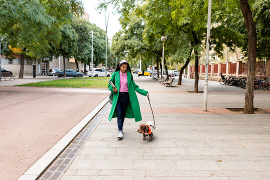 Cool woman taking a walk with her dog