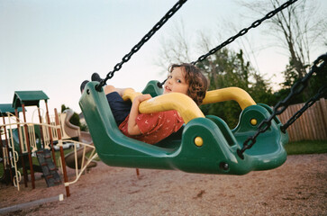 Boy swinging at the playground