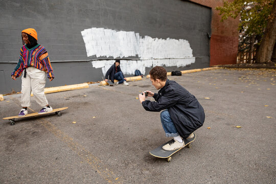 Friends Filming Each Other Skateboarding