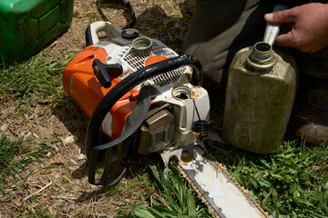 Chainsaw being refuelled