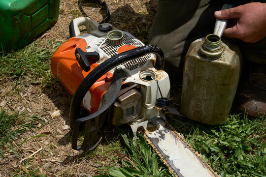 Chainsaw being refuelled