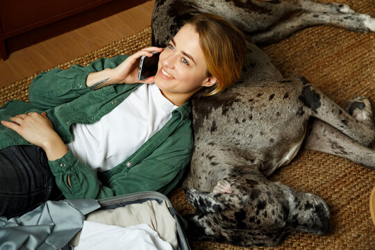 Happy dog owner answering phone call