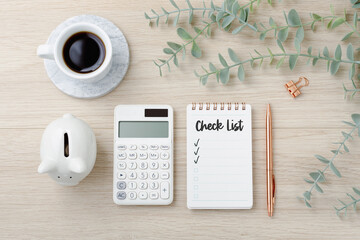 Financial planning checklist with calculator and piggy bank