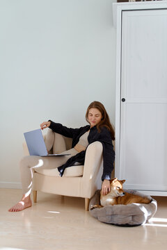 woman is sitting on a chair and talking video call