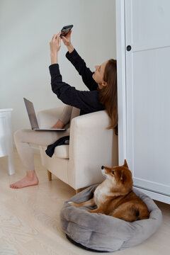 woman is sitting on a chair and talking video call