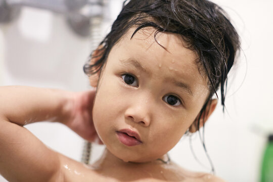 Cute Asian little girl playing in the bath

