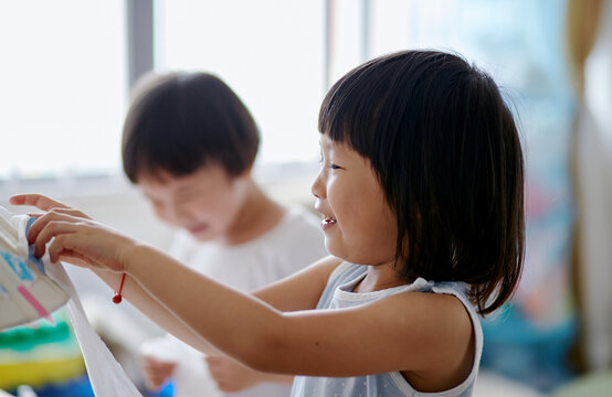 Cute Asian little girls sisters playing


