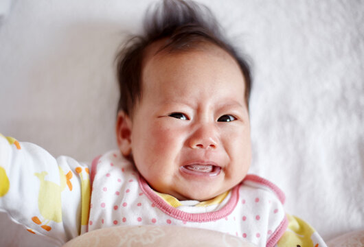 Closeup of a crying Asian newborn baby