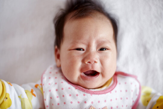 Closeup of a crying Asian newborn baby