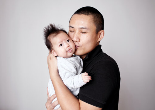 Closeup of newborn Asian baby and father