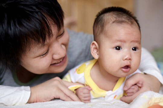 Closeup of newborn Asian baby and mom