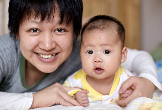 Closeup of newborn Asian baby and mom