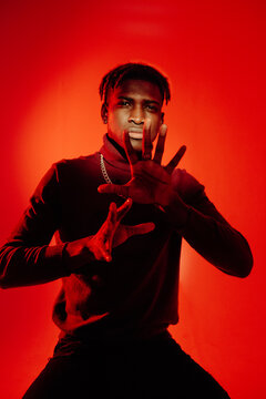 Black male model looking through palms