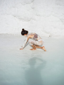Portrait of a woman with white clay at thermal pool