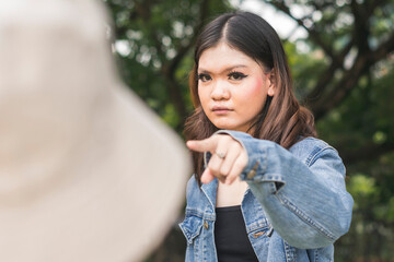 An upset confronts and accuses someone of talking behind her back, or cheating on her boyfriend.