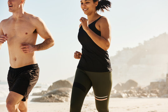 Athletic diverse athletes running on beach