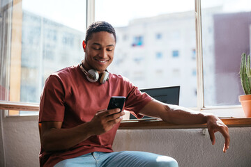 Hispanic student using smartphone at home