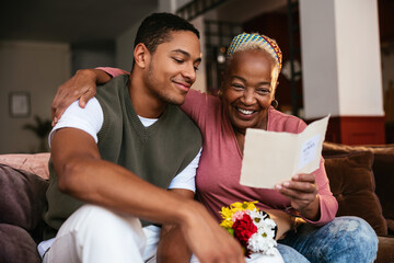 Mother and son reading greeting card