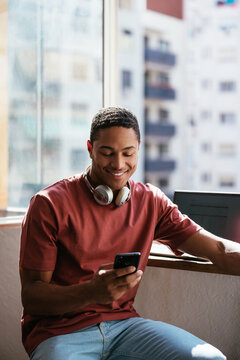 Hispanic freelancer using smartphone