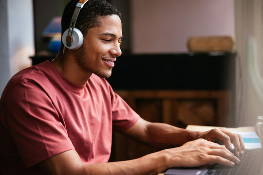 Glad student doing homework on laptop