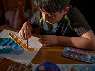 Kid Painting with a brush
