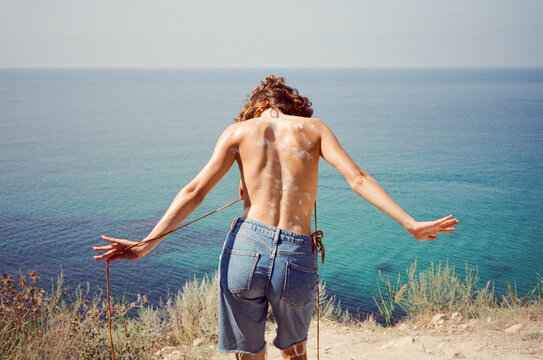 From behind look the see with sunscreen dots over her skin