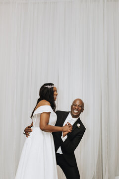 Laughing Bride and Groom in Reception Hall