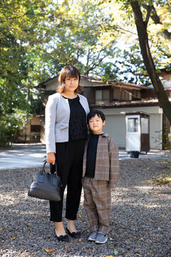Mother and son are standing gravel road
