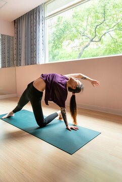 Sporty young woman doing yoga practice.