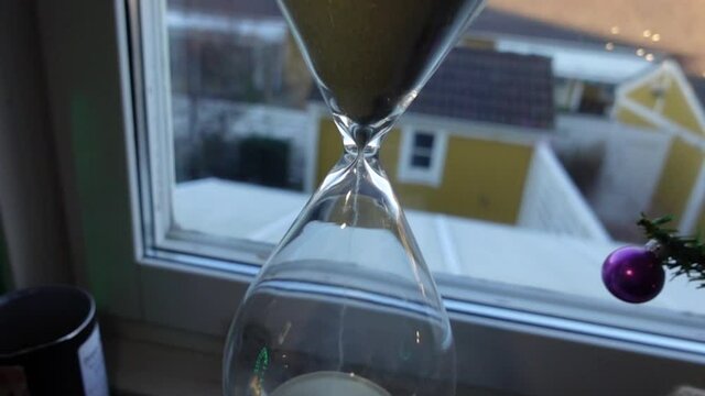 hour glass in front of the window