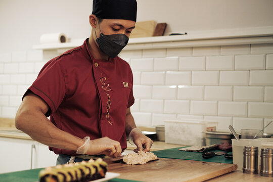 Asian chef cooking sushi in a restaurant