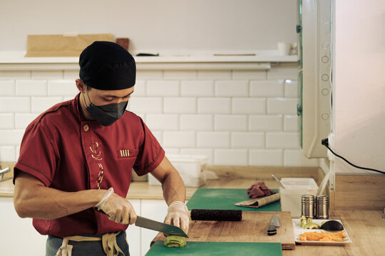 Chef prepares sushi in a restaurant