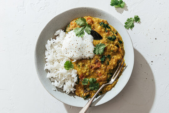 Lentil dal with spinach, tomatoes, rice and yogurt