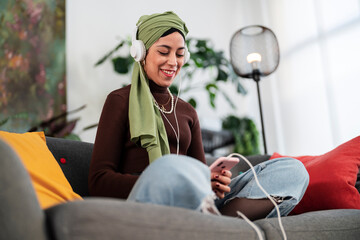 Cheerful Arab woman browsing social media