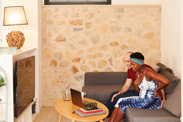 Pregnant couple smiling during a video call