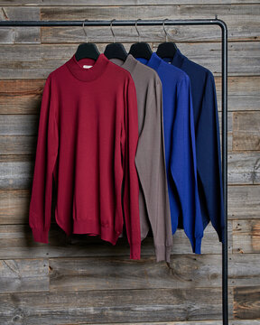 Set of pullovers on rail