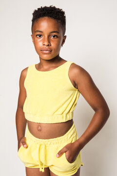 Black girl wearing yellow outfit in studio