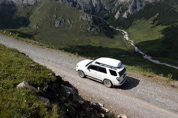 Driving off road car on high altitude mountain top