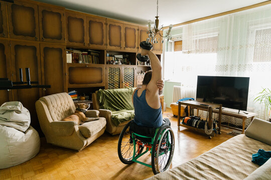 Disabled Man Weight Lifting At Home