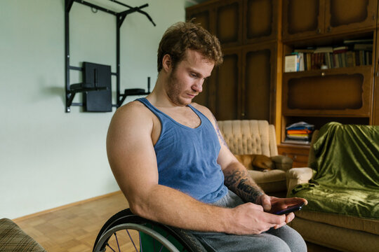 Man In A Wheelchair Using Smartphone